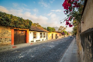 Vibrant street in a picturesque old town, featuring charming buildings adorned with colorful flowers