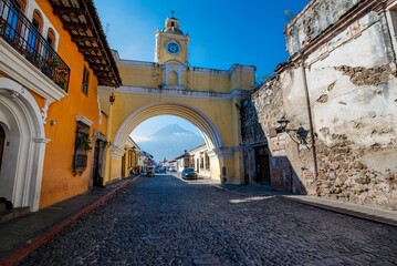 Grand archway in the middle of a cobblestone street in Antigua, Guatemala