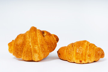 mini croissants for tea on a white background. sweet croissants with filling on a light background. colorful flour pastry