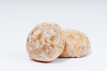 Russian gingerbread with poppy seeds on a white background. gingerbread in sweet glaze and poppy seeds on a light background. floury colorful sweets for the holiday