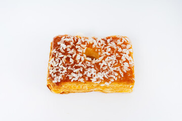 puff pastry cookies with sprinkles on a white background. baked flour muffins with coconut flakes on a light background. colorful sweets from dough for the holiday