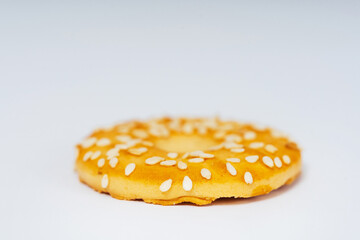 round cookies on a white background with sesame seeds. sweet cookies with sesame seeds. high-calorie flour sweets