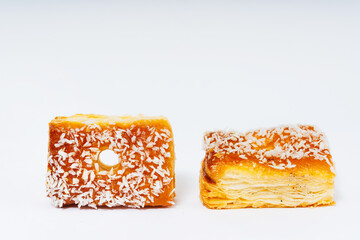 puff pastry cookies with sprinkles on a white background. baked flour muffins with coconut flakes on a light background. colorful sweets from dough for the holiday