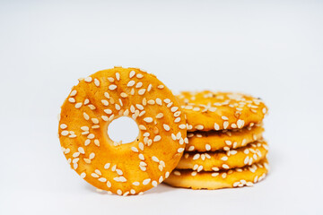 round cookies on a white background with sesame seeds. sweet cookies with sesame seeds. high-calorie flour sweets