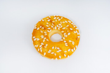 round cookies on a white background with sesame seeds. sweet cookies with sesame seeds. high-calorie flour sweets