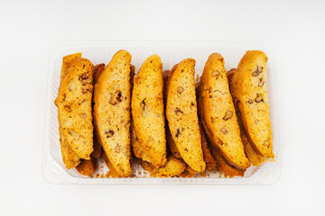 baked slices of bread with nuts on a light background. sweet white bread cooked in the oven. flour sweets on a white background