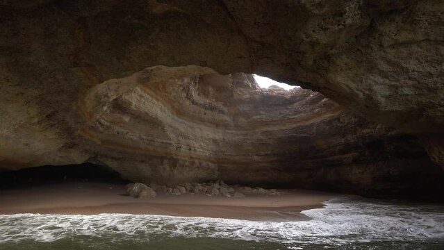 Beautiful Benagil cave in Lagoa, Portugal and the foamy waves of the sea