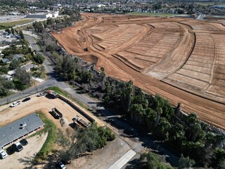 the aerial view of a dirt field and lots of trees