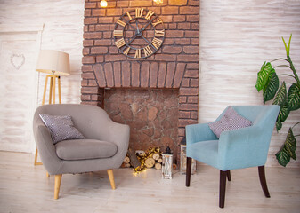 Comfortable reading chair in the room near the fireplace. Furniture of different styles. Relax and...