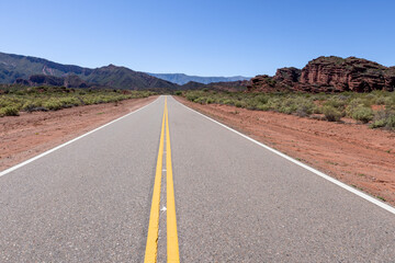 Driving through the stunning, reddish landscape of Ischigualasto Provincial Park in San Juan Province, Argentina - traveling South America 
