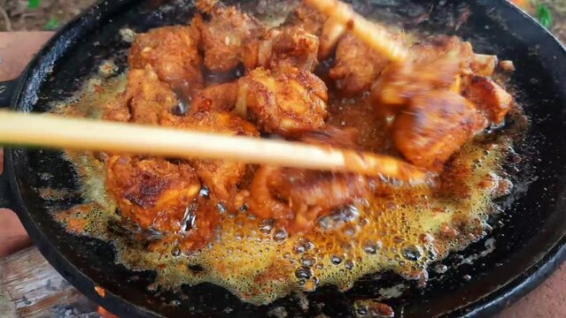 Cooking red chicken roast curry Goan chicken vindaloo. Butter chicken Murgh Makhani hot spicy dish Kerala Punjab India North Indian non vegetarian cuisine Garam Masala tikka.