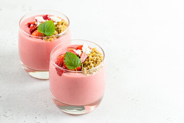 Strawberry muesli yogurt dessert in glasses. Copy space, flat lay.