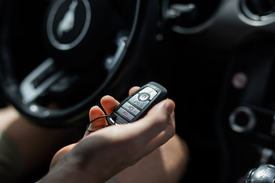 Key car fob female hand holding steering wheel travel explore open unlock opportunity lock secure safe