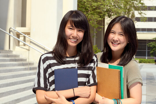 University, portrait of asian friends on campus and with books happy for learning development. Education or knowledge, positivity or academy and students together at college building outdoor