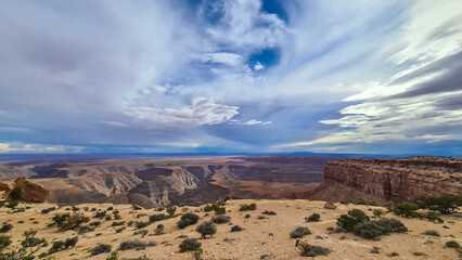 Scenic aerial vistas of desert landscape and canyons of Valley of the Gods seen from remote cliff Muley Point near Mexican Hat, San Juan county, Utah, USA. Monument valley seen in the distance