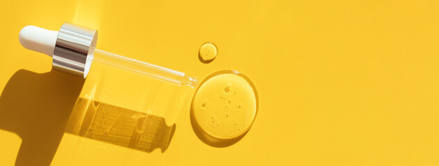 pipette drop of serum test on a yellow background sun glare