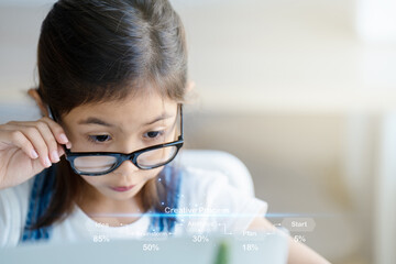 A girl is using a laptop computer for education and learning online.