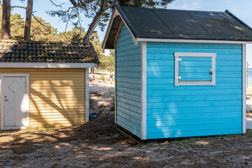 Fototapeta na wymiar Colorful beach huts, little wooden houses on the beach, glamping tourism