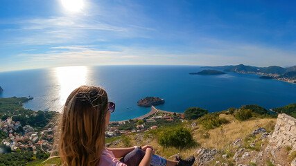 Tourist woman on viewing platform at chapel Saint Sava with aerial scenic view of idyllic island...