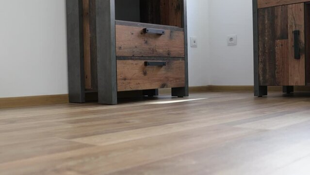 New laminate flooring. Laminated parquet with brown wooden texture