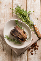 roasted pigeon with dried grape and rosemary