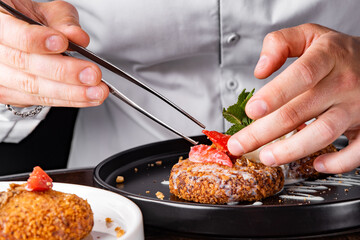 chef hand decorated cheese pancakes with ice cream and sweet sauce