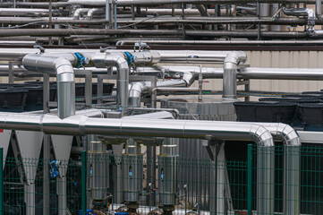 Equipment, cables and pipelines outside a modern cheese factory in France, close-up