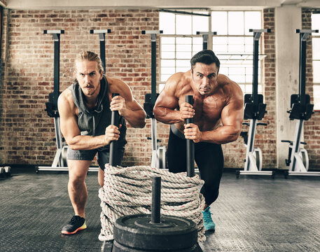 Men, weights exercise and together with sled, rope and strong for fitness, health and training on floor. Body builder partnership, friends and teamwork for workout, coaching and muscle development