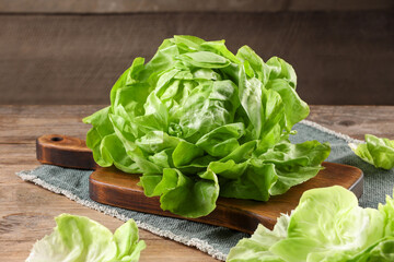 Fresh green butter lettuce on wooden table, closeup