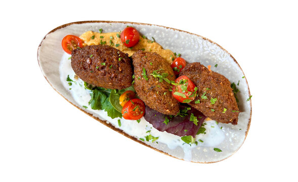Freshly made falafel with hummus and yoghurt on a plate. High angle view with copy space