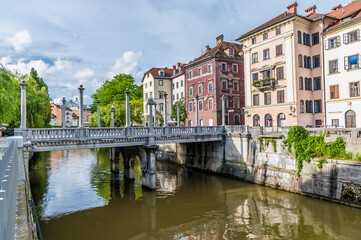 Fototapeta na wymiar A view up the River Ljubljanica towards the Shoemakers bridge in Ljubljana, Slovenia in summertime