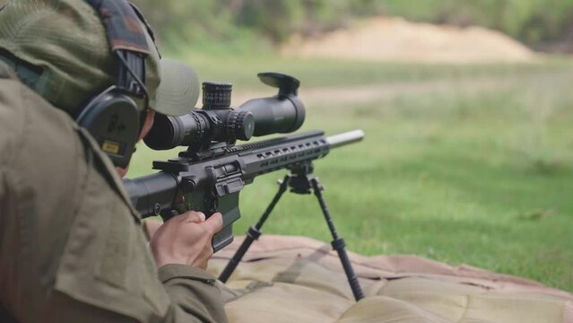 Slow motion of soldier during training with sniper caliber 7.62 mm at Firing Range - Close up