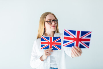 Young blondie woman in eye glasses with british flag