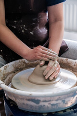 Close up of a person working on a pottery wheel. Pottery Concept. Ceramics. Artistic.