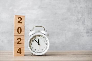 Happy New Year with vintage alarm clock and 2024 block. Christmas, New Start, Resolution,...