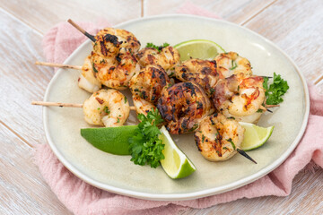 Grilled shrimp skewers. Seafood, shelfish. Shrimps Prawns skewers with lime. Barbecue srimps prawns.