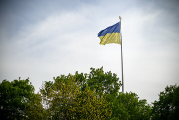 Ukraine flag large national symbol fluttering in blue sky. Large yellow blue Ukrainian state flag, Dnipro city, Independence Constitution Day, National holiday