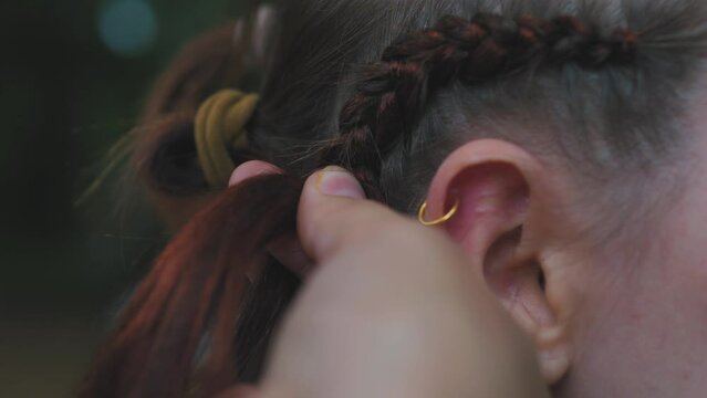 Process of weaving making boxer braids cornrows by a hair braider.