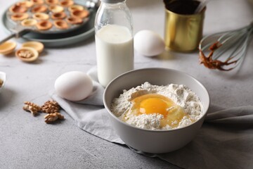 Fresh ingredients for preparing walnut shaped cookies on light grey table. Space for text