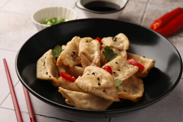 Delicious gyoza (asian dumplings) in bowl on table