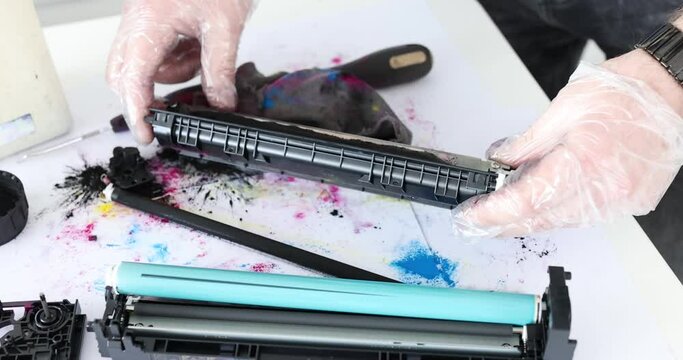 Service man refilling cartridges againt white table 4k movie