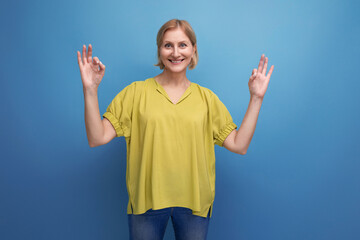 middle-aged blond woman in casual dress waving her arms