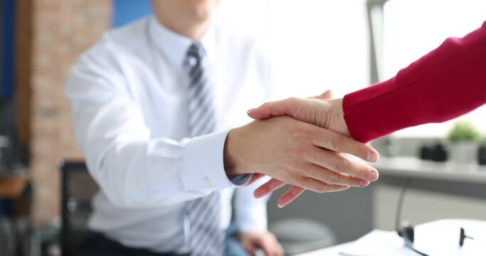 Businessman meeting colleague and giving her hand 4k movie. Work with clients concept