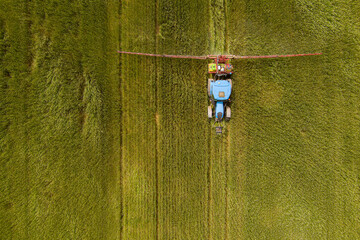Tractor spraying agricultural fields