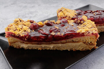 Cherry pie close-up on a black plate