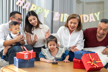 Portrait of happy love asian big family father and mother with asian baby and little girl happy birthday, party, celebration, cake, surprise, grandfather with grandmother smiling together.Family party