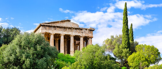 Panoramic view of ancient greek temple of Hephaestus against blue sky background in Agora in Athens center, Greece.