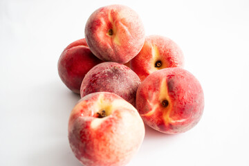 Fototapeta na wymiar ripe peaches on a white background. top view. close up. fresh peaches in a bowl on a white background.