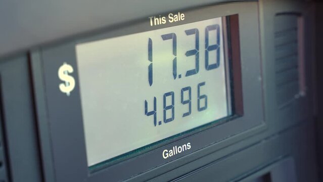 Fuel pump screen showing rising price of gasoline at gas station