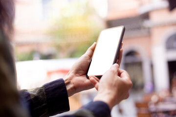 cell phone blank white screen mockup.hand holding texting using mobile on desk at office.background empty space for advertise.work people contact marketing business,technology
